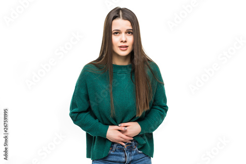 Young pretty woman with stomack pain wearing in green sweater isolated on white background photo