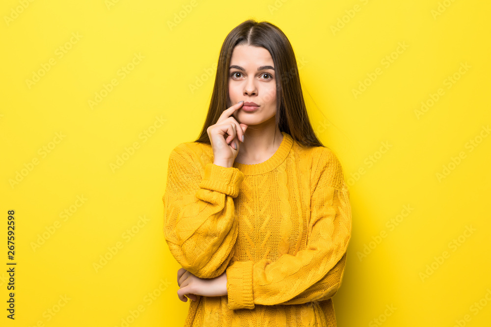 Young pretty woman thinking wearing in yellow sweater isolated on yellow background Young pretty woman thinking wearing in yellow sweater isolated on yellow background