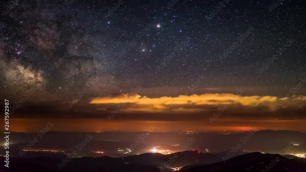Milky Way passes the clouds on the horizon lit 4K Time Lapse Stock ...