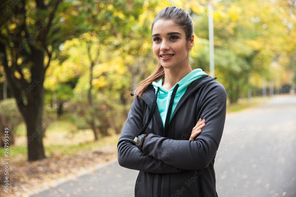 Beautiful young pretty fitness woman runner have a rest outdoors in the park. Beautiful young pretty fitness woman runner have a rest outdoors in the park.