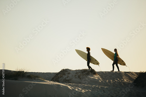 Photography Friends going on surfing in the ocean