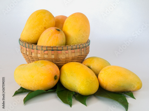 ripe mangos in a basket on a white background