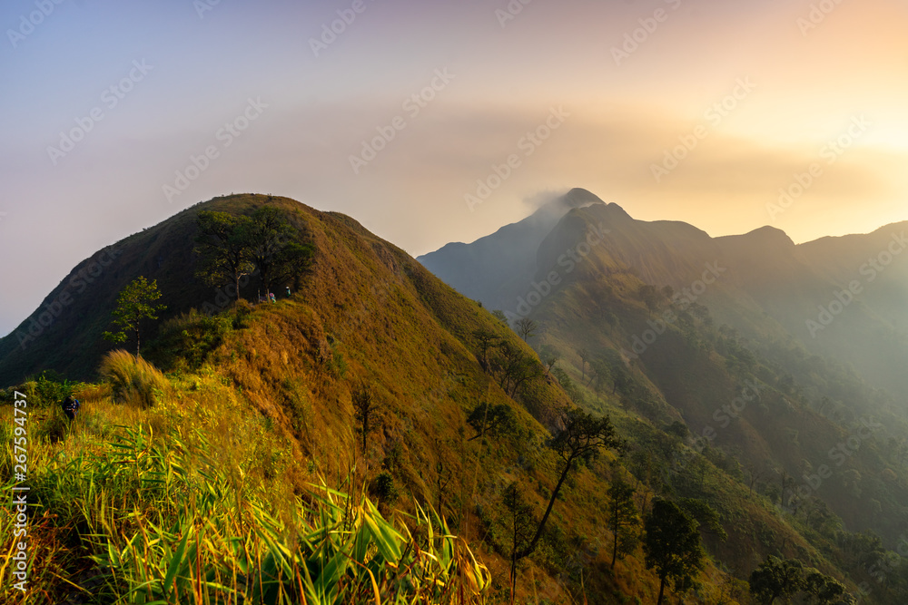 Mountain peak range landscape.  Green mountain range view. The peak of the sun shining in the early morning,Khao Chang Phueak is a mountain in Thailand's Thong Pha Phum National Park.