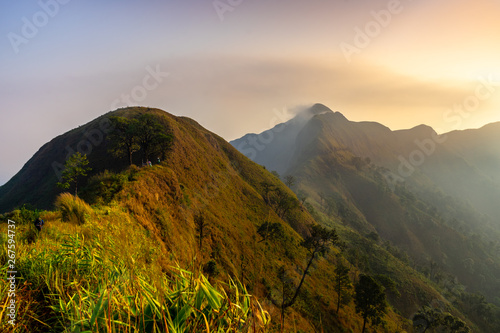 Mountain peak range landscape. Green mountain range view. The peak of the sun shining in the early morning,Khao Chang Phueak is a mountain in Thailand's Thong Pha Phum National Park.