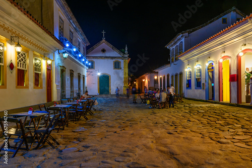 Night view of street of historical center with tables of restaurant in Paraty, Rio de Janeiro, Brazil. Paraty is a preserved Portuguese colonial and Brazilian Imperial municipality