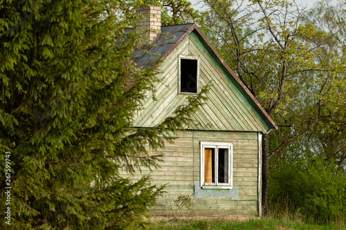 Abandoned wooden house painted in green