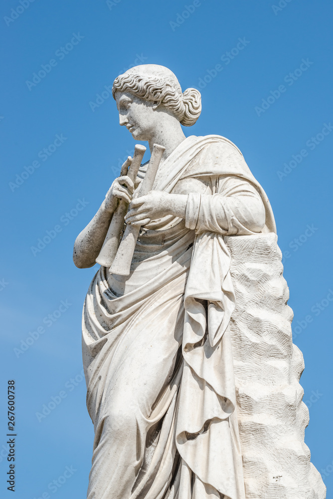 Ancient statue of a sensual renaissance era woman with musical instruments as pipes, in Potsdam, Germany Ancient statue of a sensual renaissance era woman with musical instruments as pipes, in Potsdam, Germany