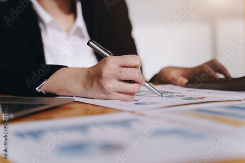 Businesswoman working with  new startup project using calculator to calculate numbers. Business financial and accounting concept.
