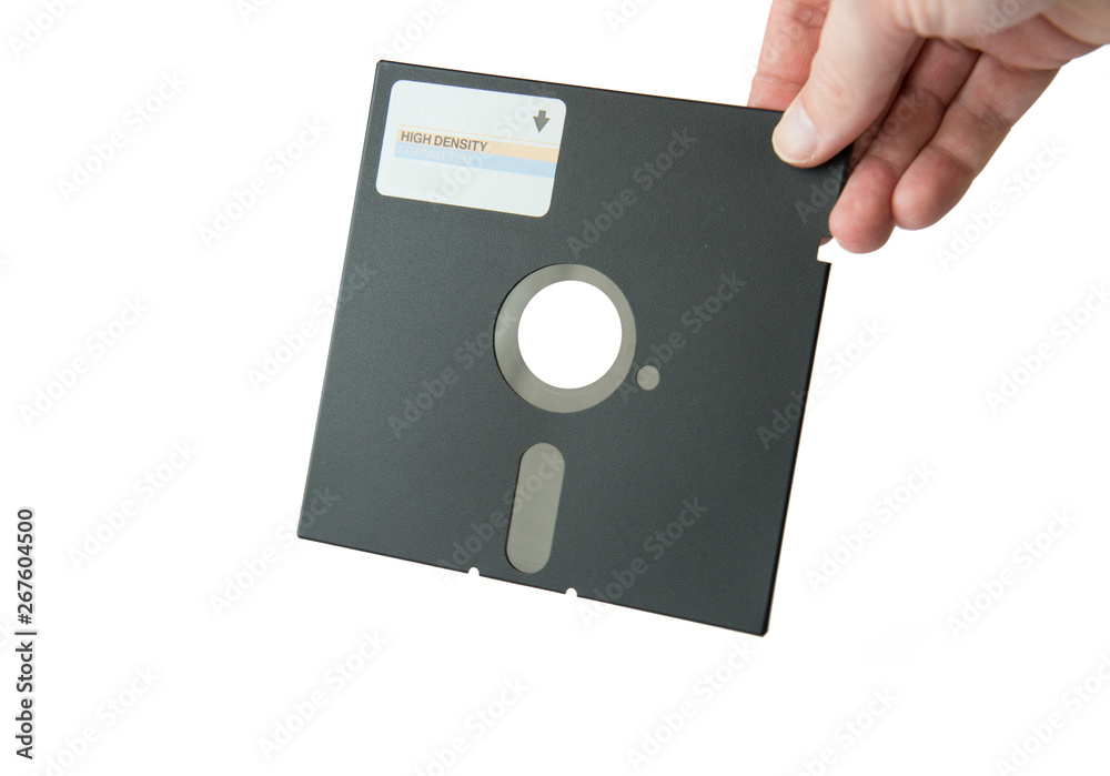an isolated 5.25 floppy disk held by a hand an isolated 5.25 floppy disk held by a hand