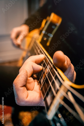 hand playing a guitar and touching a string instrument musician session recording show concert live human musician composer craft position sound