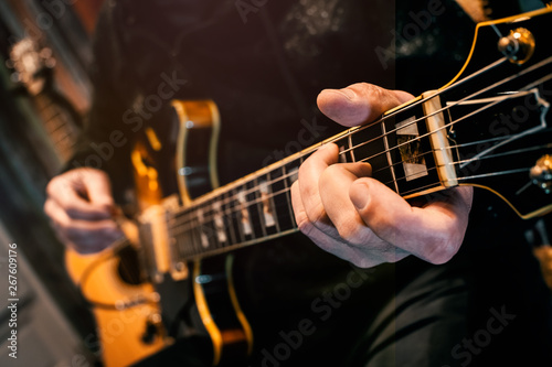 man playing a chord electric guitar musical rock r and b melody tune modulation sound concert player hand band rehersal recording harmony classical art song cadence melodic jazz rhythm live show 