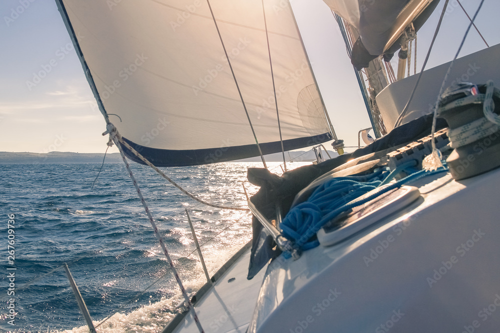 Obraz premium Sailing at sunset, white yacht and sea