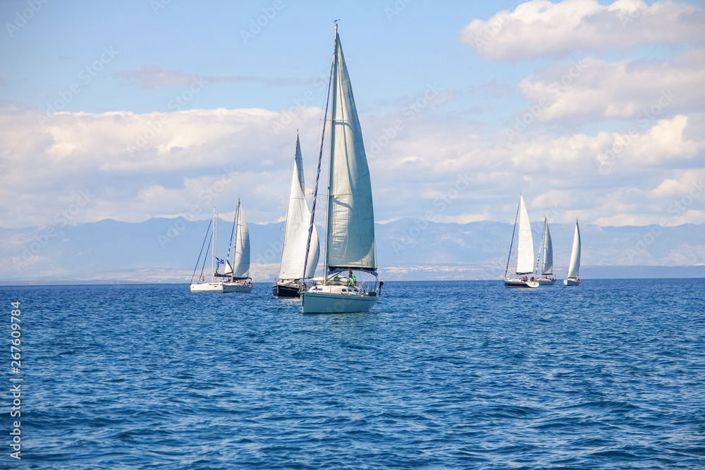 Group of yacht at sea with mountains in the background. Sailing in Croatia