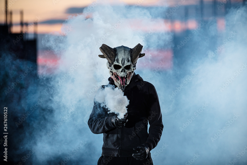 Devil with scary mask surrounded by white smoke Devil with scary mask surrounded by white smoke