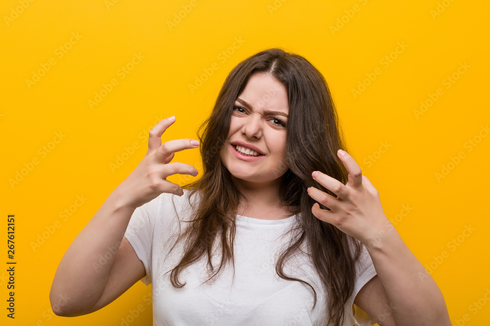 Young curvy plus size woman upset screaming with tense hands. Young curvy plus size woman upset screaming with tense hands.