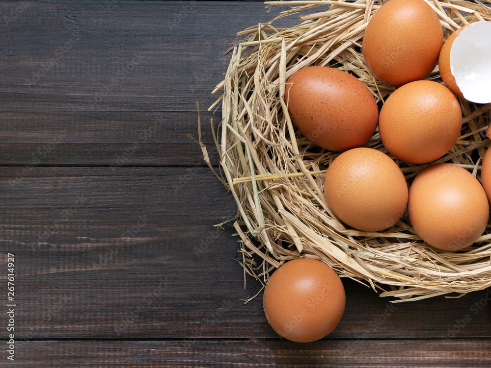 Eggs on a straw with a wooden background background top view Eggs on a straw with a wooden background background top view