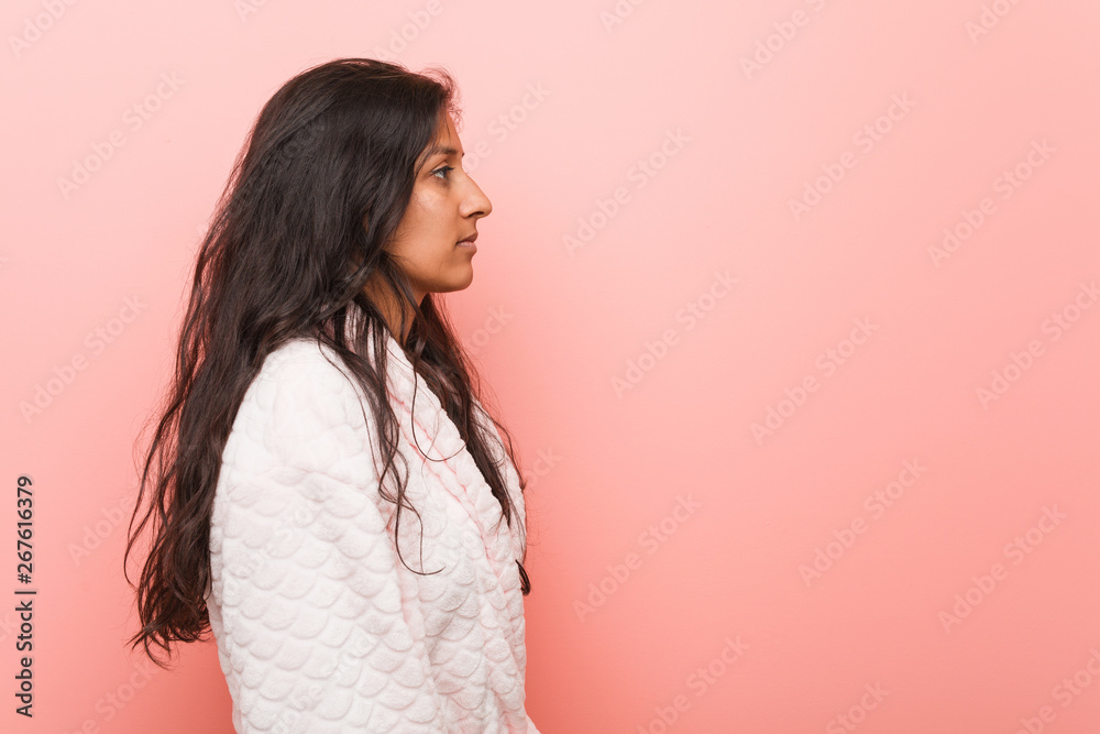 Young indian woman wearing pajama gazing left, sideways pose. Young indian woman wearing pajama gazing left, sideways pose.