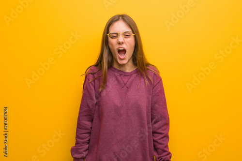 Young casual woman screaming very angry and aggressive © Asier