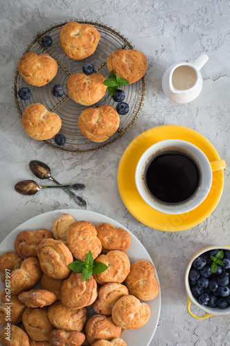 Italian healthy breakfast: homemade cookies - biscotti - made from ricotta, fresh blueberries, barley coffee, coconut milk