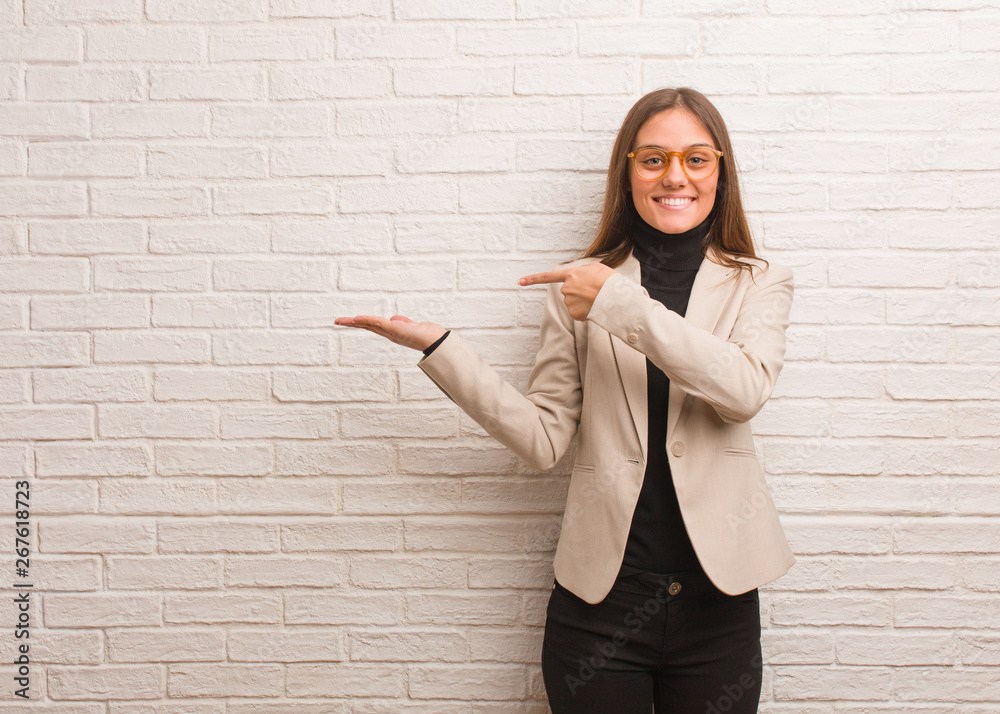 Young pretty business entrepreneur woman holding something with hand Young pretty business entrepreneur woman holding something with hand