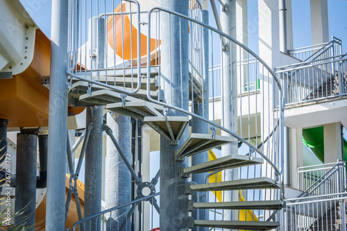 Curved ladder for rise on waterslide in aquapark.
