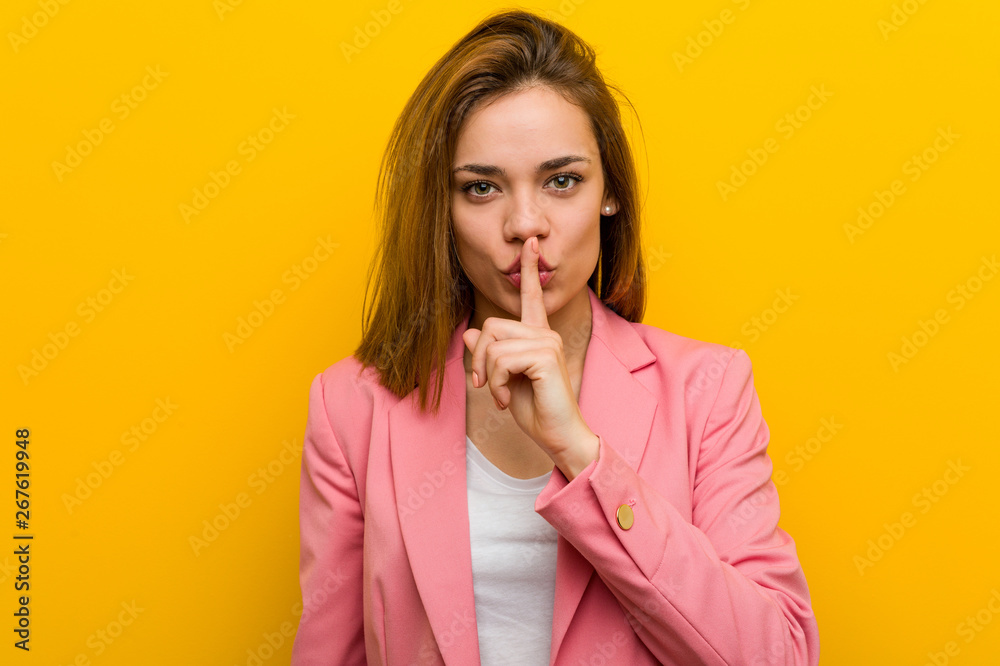 Young fashion business woman keeping a secret or asking for silence. Young fashion business woman keeping a secret or asking for silence.