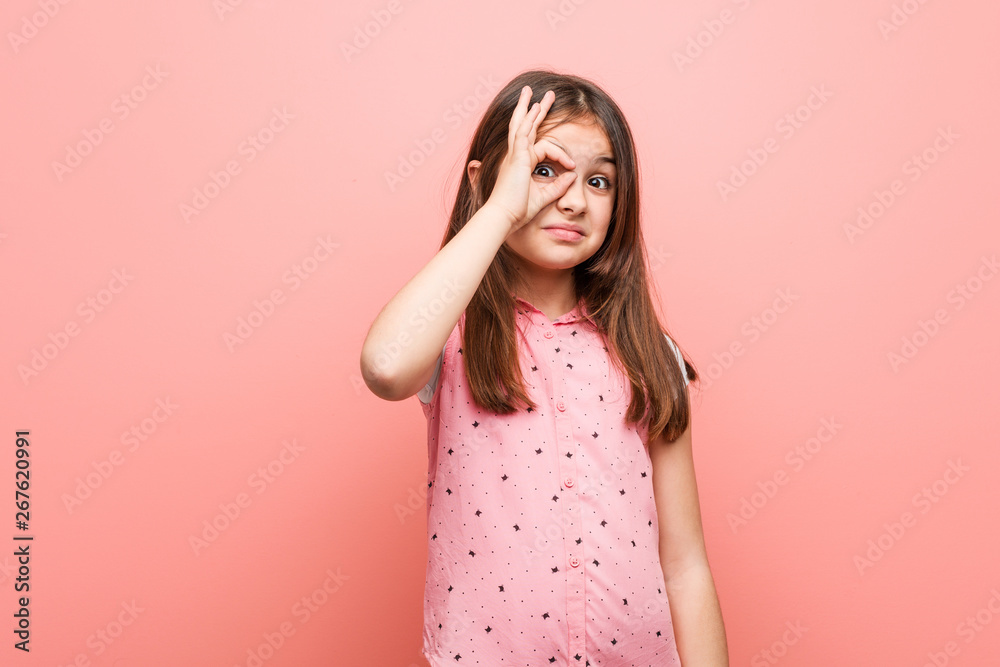 Cute little girl excited keeping ok gesture on eye. Cute little girl excited keeping ok gesture on eye.