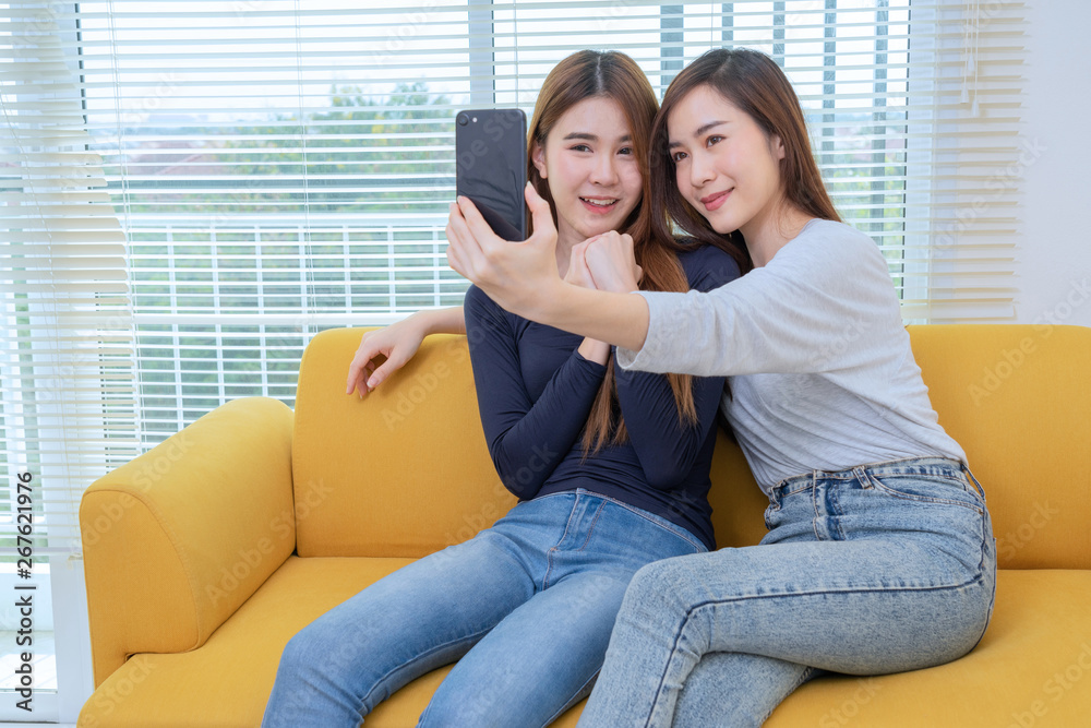 A couple of beautiful asian woman take photo while smiling, Same sex young married female couple in their daily routine showing some affection LGBT lesbian Stock Photo Adobe Stock