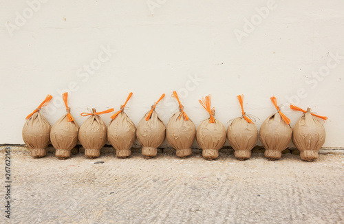 Firework powder bags in a row by a wall, Malta