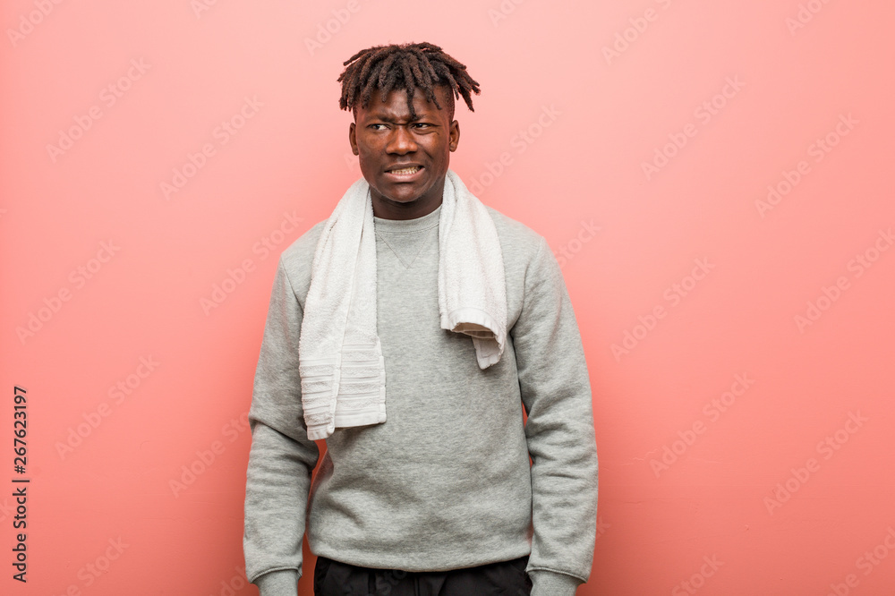 Young fitness african black man confused, feels doubtful and unsure.