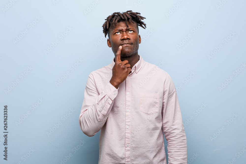 Young business african black man looking sideways with doubtful and skeptical expression. Young business african black man looking sideways with doubtful and skeptical expression.