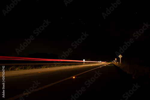 Motion light of the car on the road in the dark night.