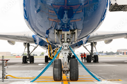 The front landing gear of the aircraft standing on the refueling at the airport. © melnikviva