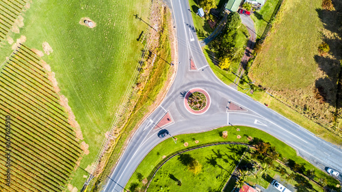 Road intersection surrounded by small farms and vineyards. Auckland, New Zealand photo