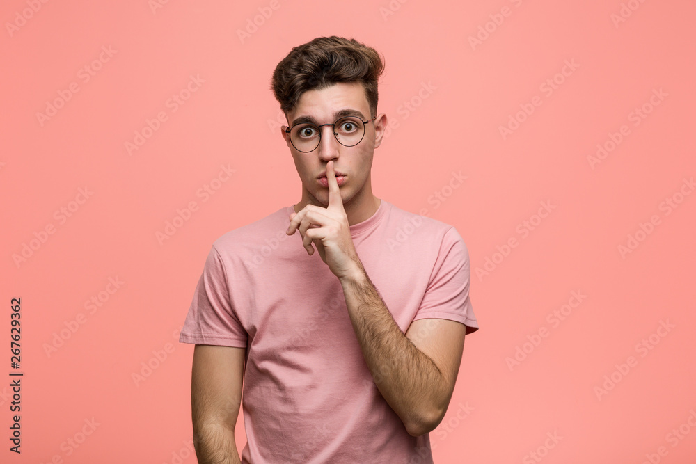 Young cool caucasian man keeping a secret or asking for silence. Young cool caucasian man keeping a secret or asking for silence.