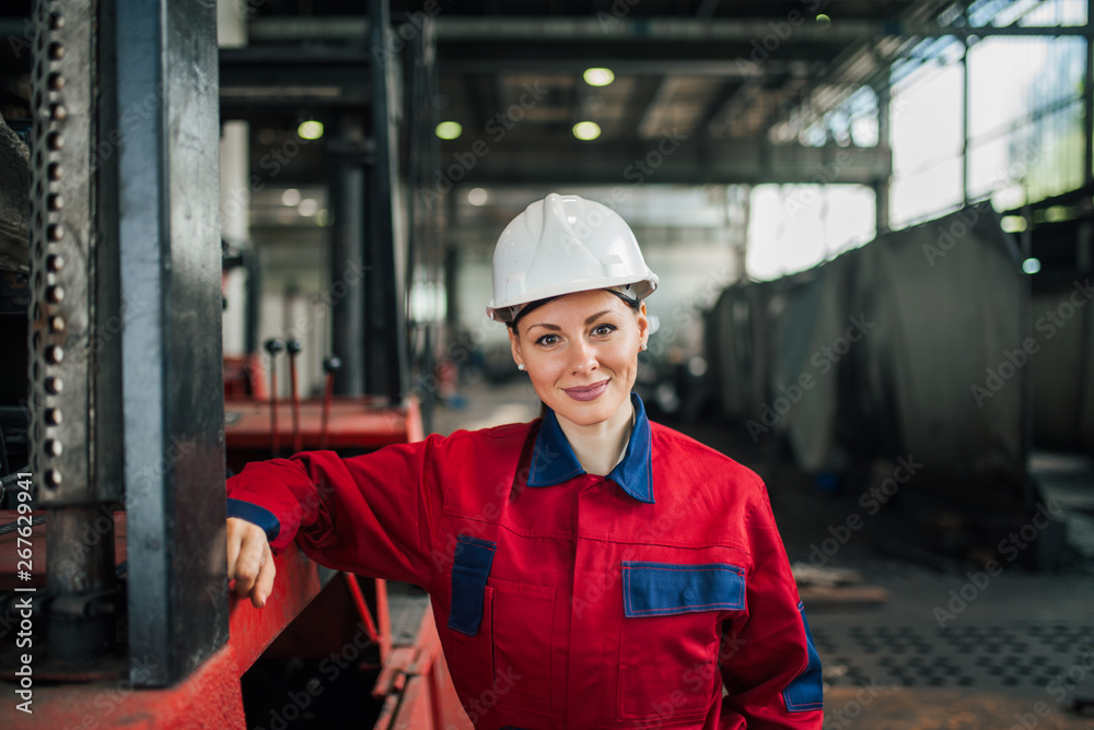 Portrait of a beautiful female engineer at the factory.