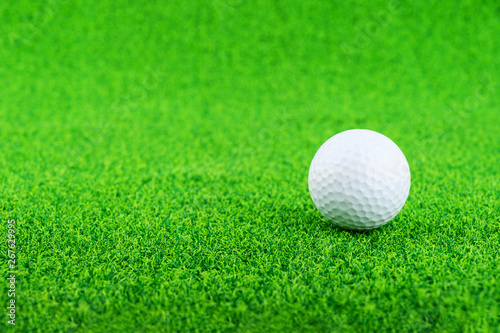 Golf ball put on the green grass