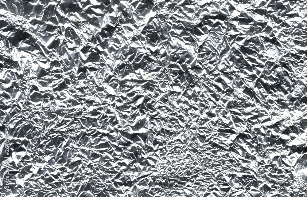 foil texture background. Thin sheet of silver leaf background with shiny uneven surface foil texture background. Thin sheet of silver leaf background with shiny uneven surface