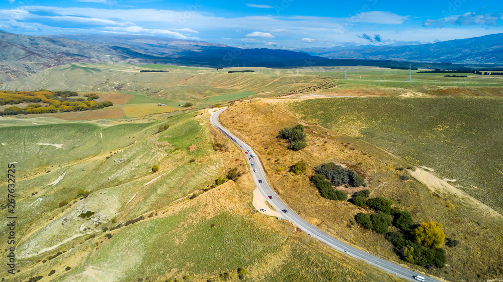 Road running through hills and farmland. Otago, South Island, New Zealand