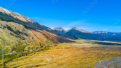 River valley with road running along the foot of the mountain. West Coast, South Island, New Zealand