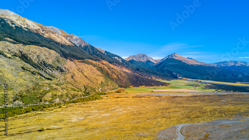 Mountains with farmland on the foreground. West Coast  South Island  New Zealand.
