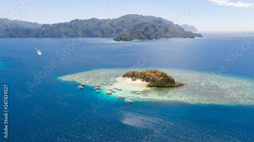 tropical island with coral reefs. Philippine Islands in clear weather aerial view. Philippines, Palawan