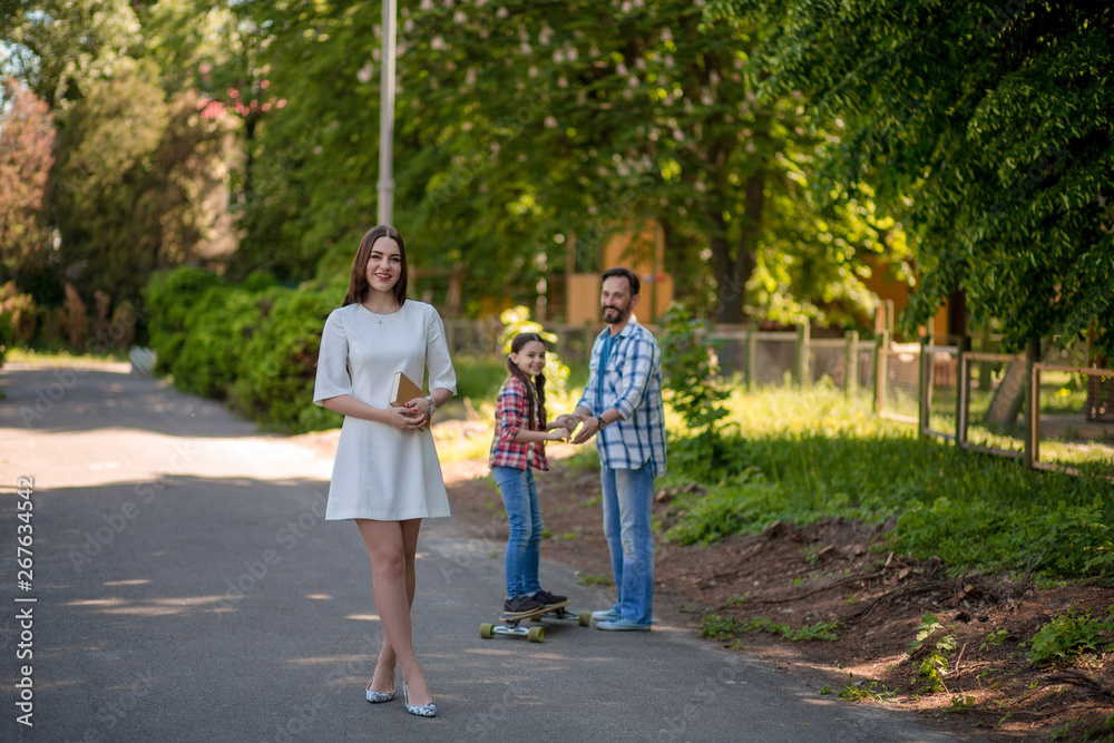 happy young family spending time in park on summer day happy young family spending time in park on summer day