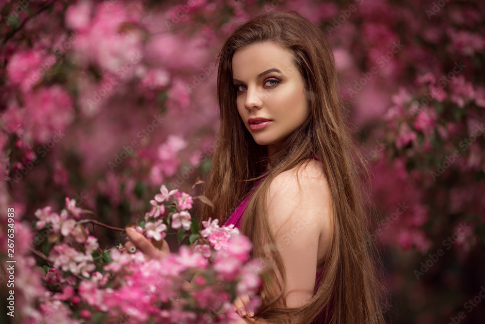 Beautiful girl in blossom apple garden with pink flowers, spring time Beautiful girl in blossom apple garden with pink flowers, spring time