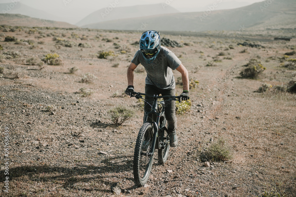 Spain, Lanzarote, mountain biker on a trip in desertic landscape Spain, Lanzarote, mountain biker on a trip in desertic landscape