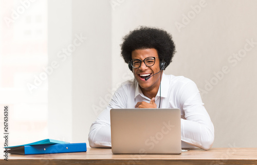 Young telemarketer black man laughing and having fun