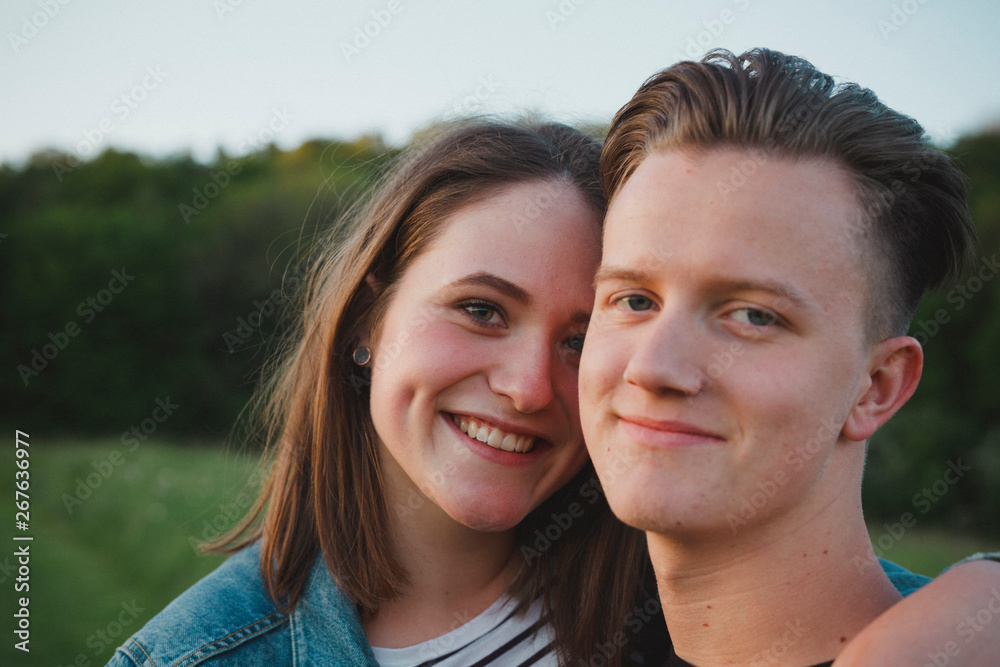 Portrait of happy young couple in love by sunset Portrait of happy young couple in love by sunset