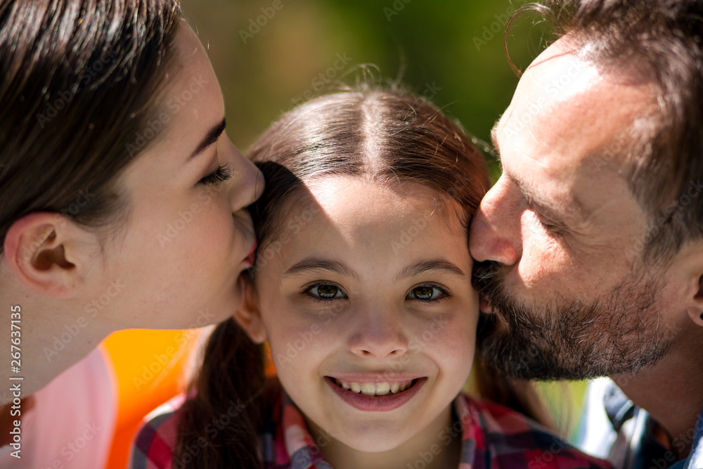 Happy family enjoying time in summer park Happy family enjoying time in summer park