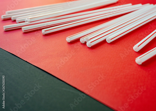 Colorful straw cocktail on red background