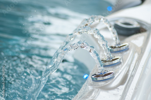 closeup of jet of water in swirl bath photo